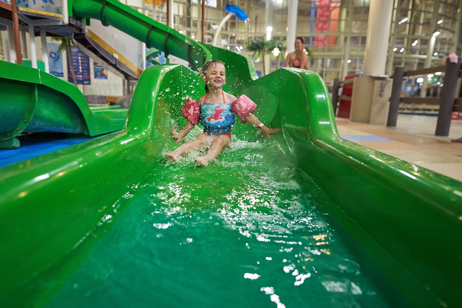 Child enjoying an indoor water slide