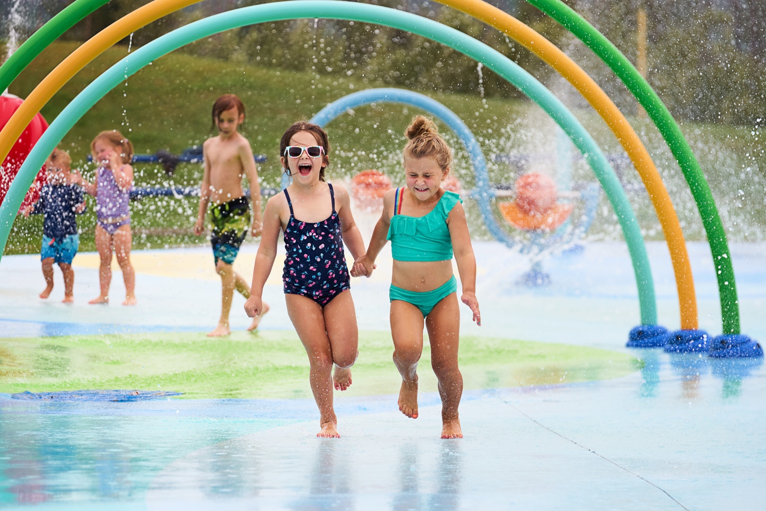 Children running through a splash park