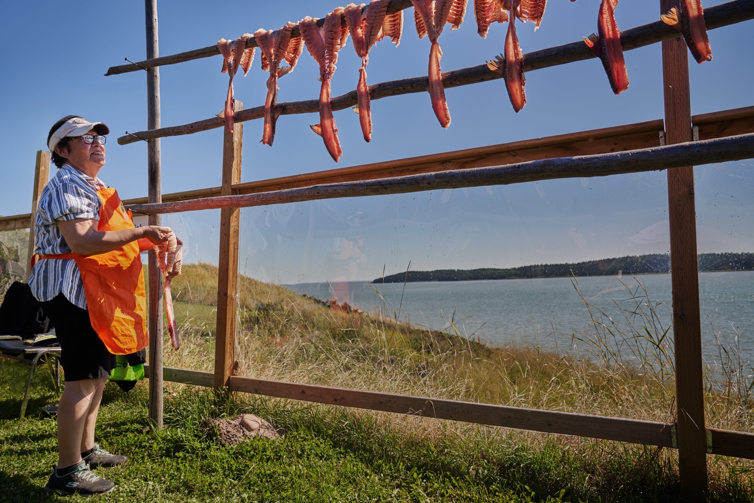 Traditional fish drying beside a river, representing heritage and cultural storytelling