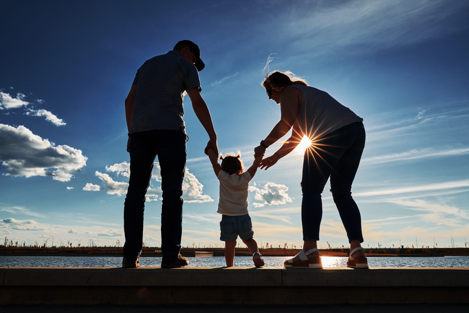 Father and children smiling together outdoors