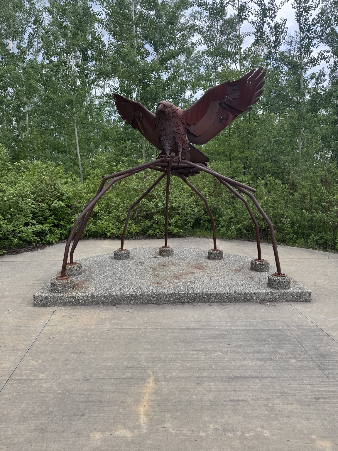 Large eagle public art sculpture hidden among trees