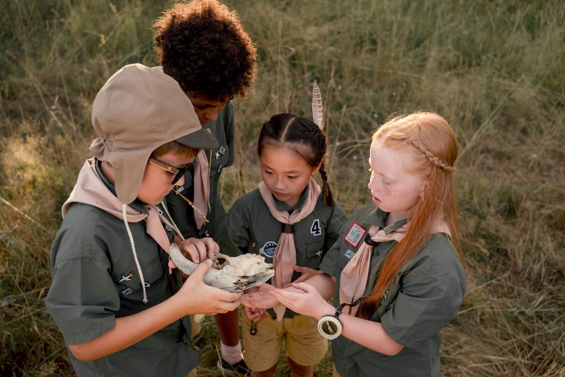 Children examining an object outdoors as part of a discovery activity