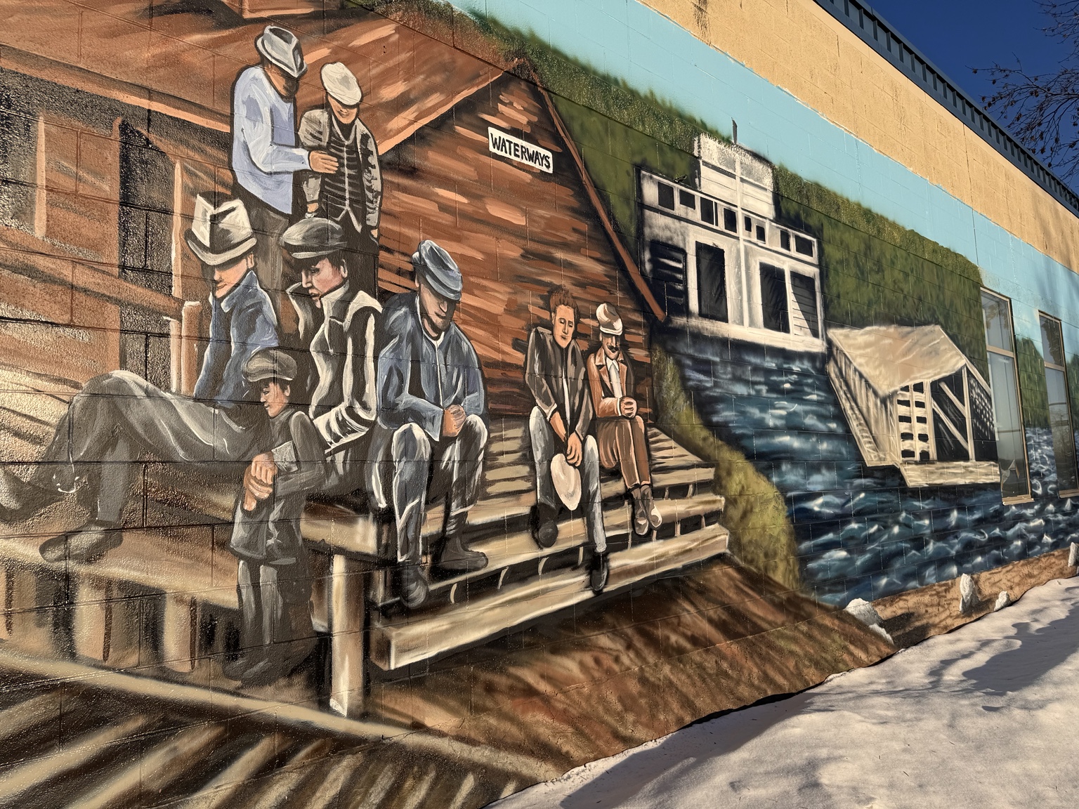 Heritage mural showing historic Waterways buildings, people and northern river history